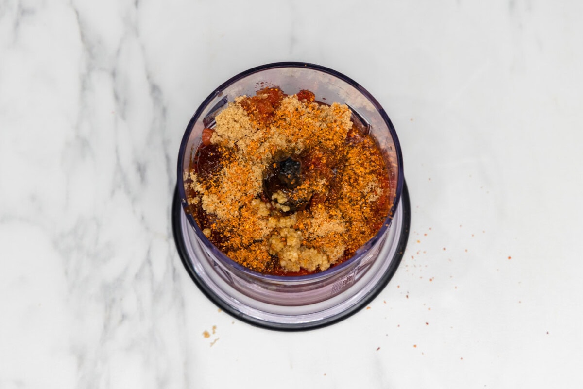 canned tomatoes, chipotles, brown sugar, Cajun seasoning, and garlic in a mini chopper