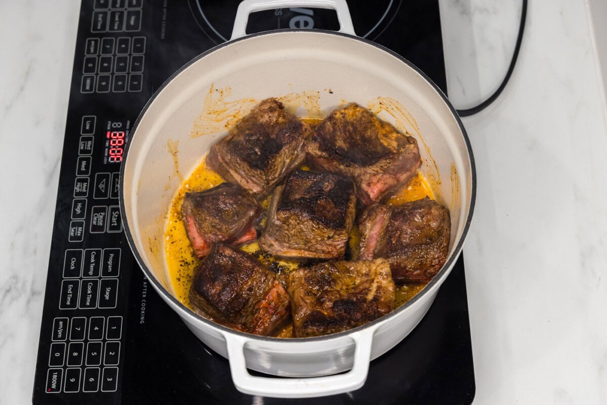 seared short ribs in a dutch oven