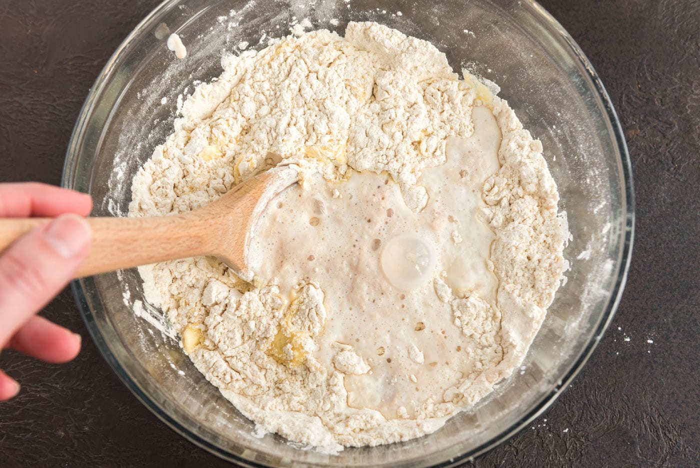 stirring flour with yeast and butter mixture