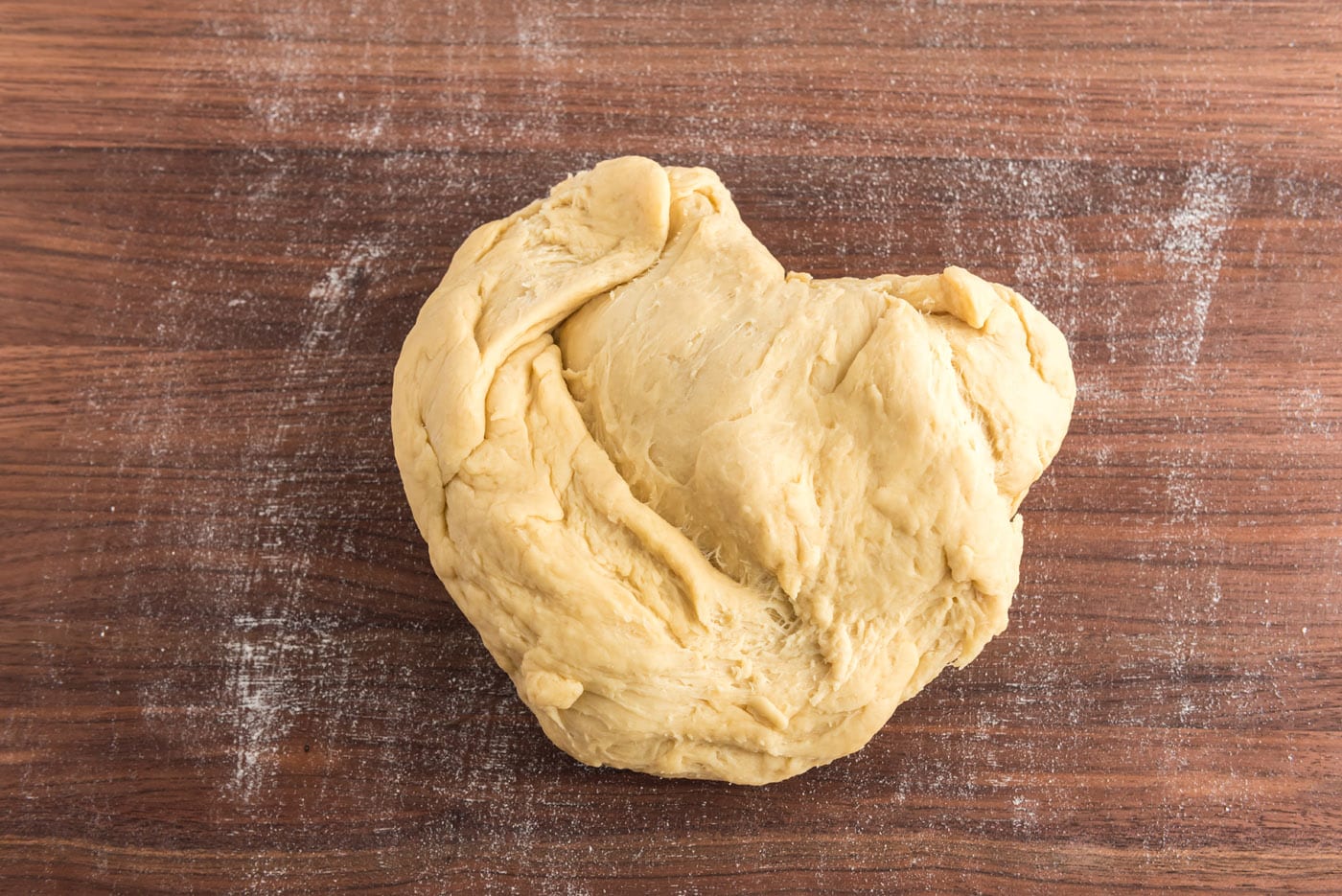 kneading yeast dough on cutting board