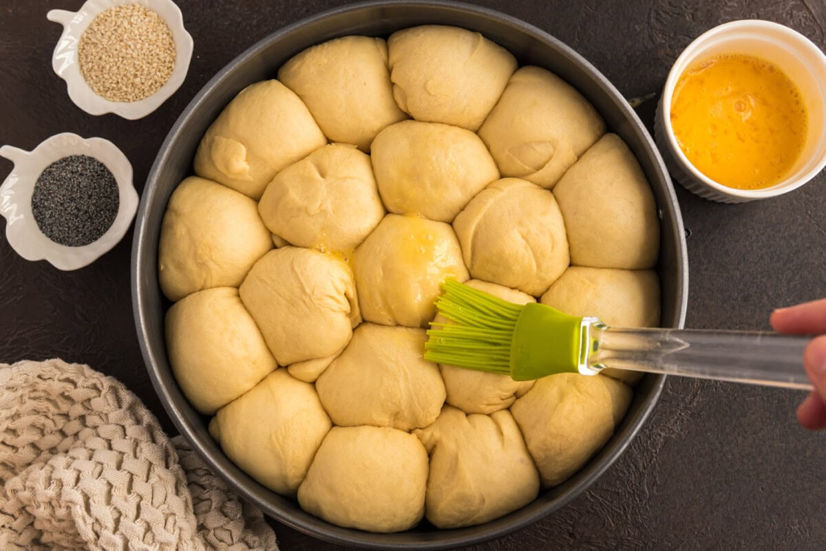 brushing dough balls with butter