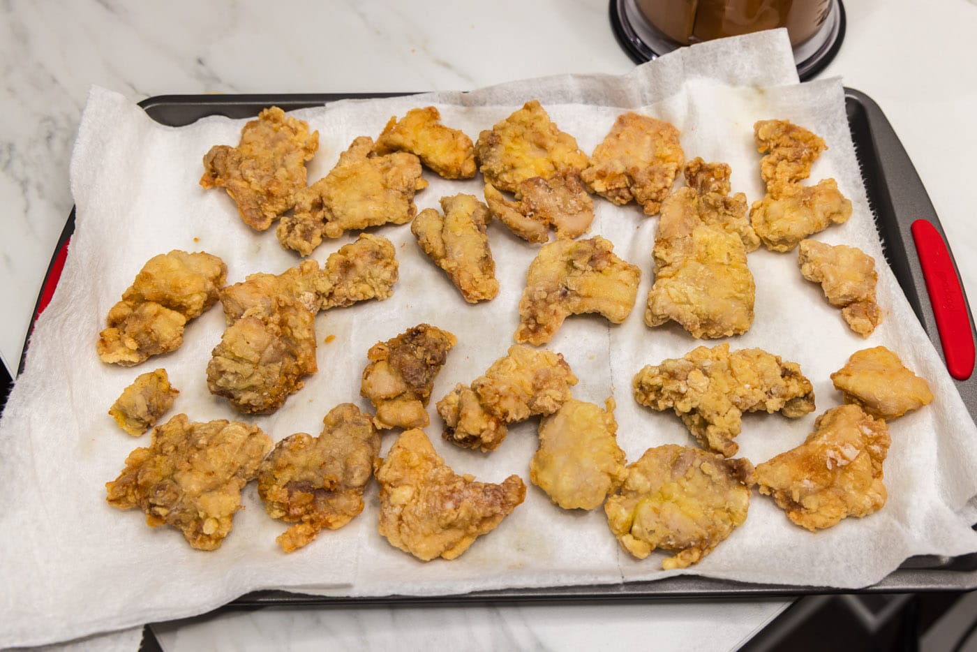 crispy coated chicken pieces on a paper towel