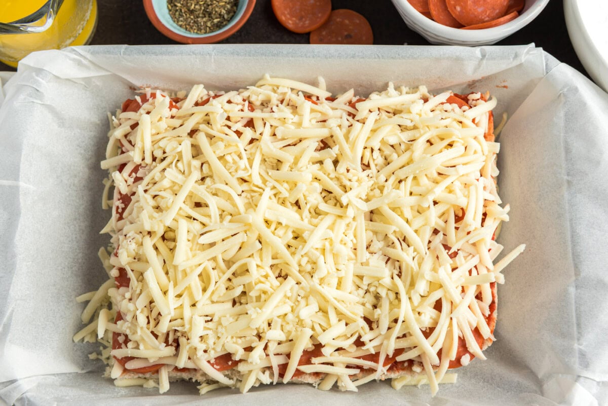 layer of cheese on top of pepperoni pizza sliders