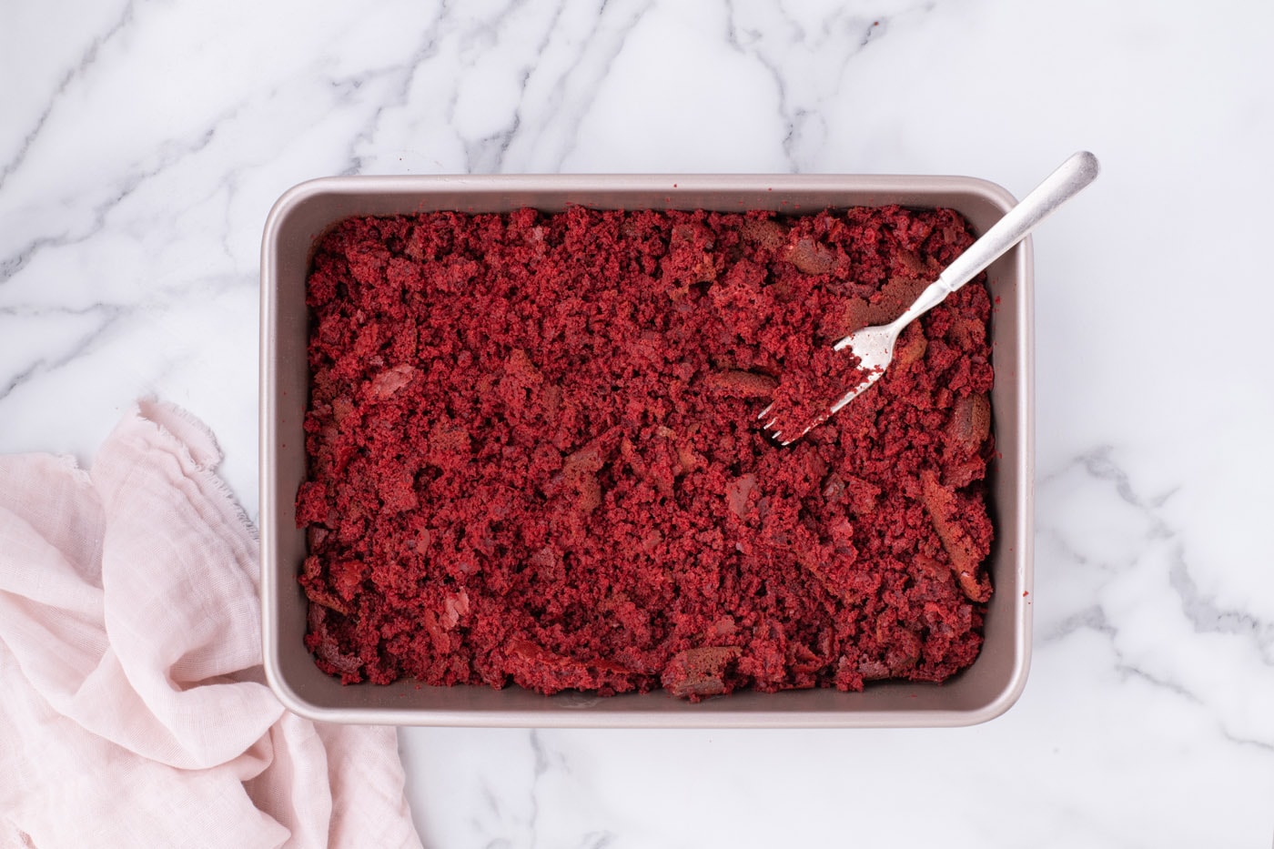crumbled red velvet cake in a baking dish