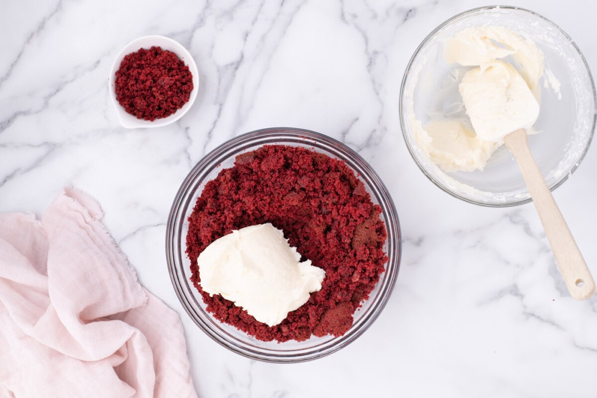 cream cheese frosting added to crumbled red velvet cake
