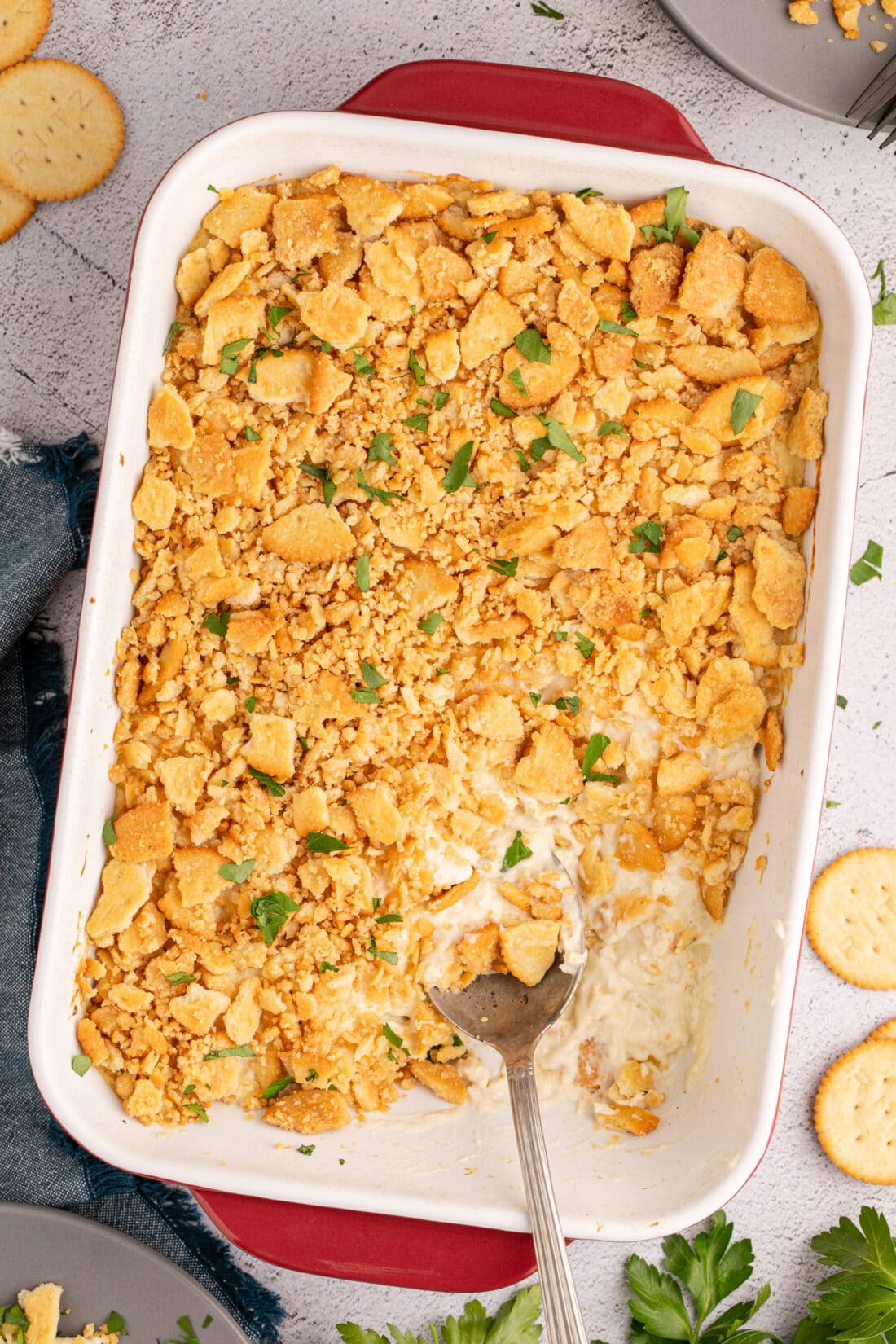 Overhead photo of a Ritz Cracker Chicken Casserole in a casserole dish with a spoon in it