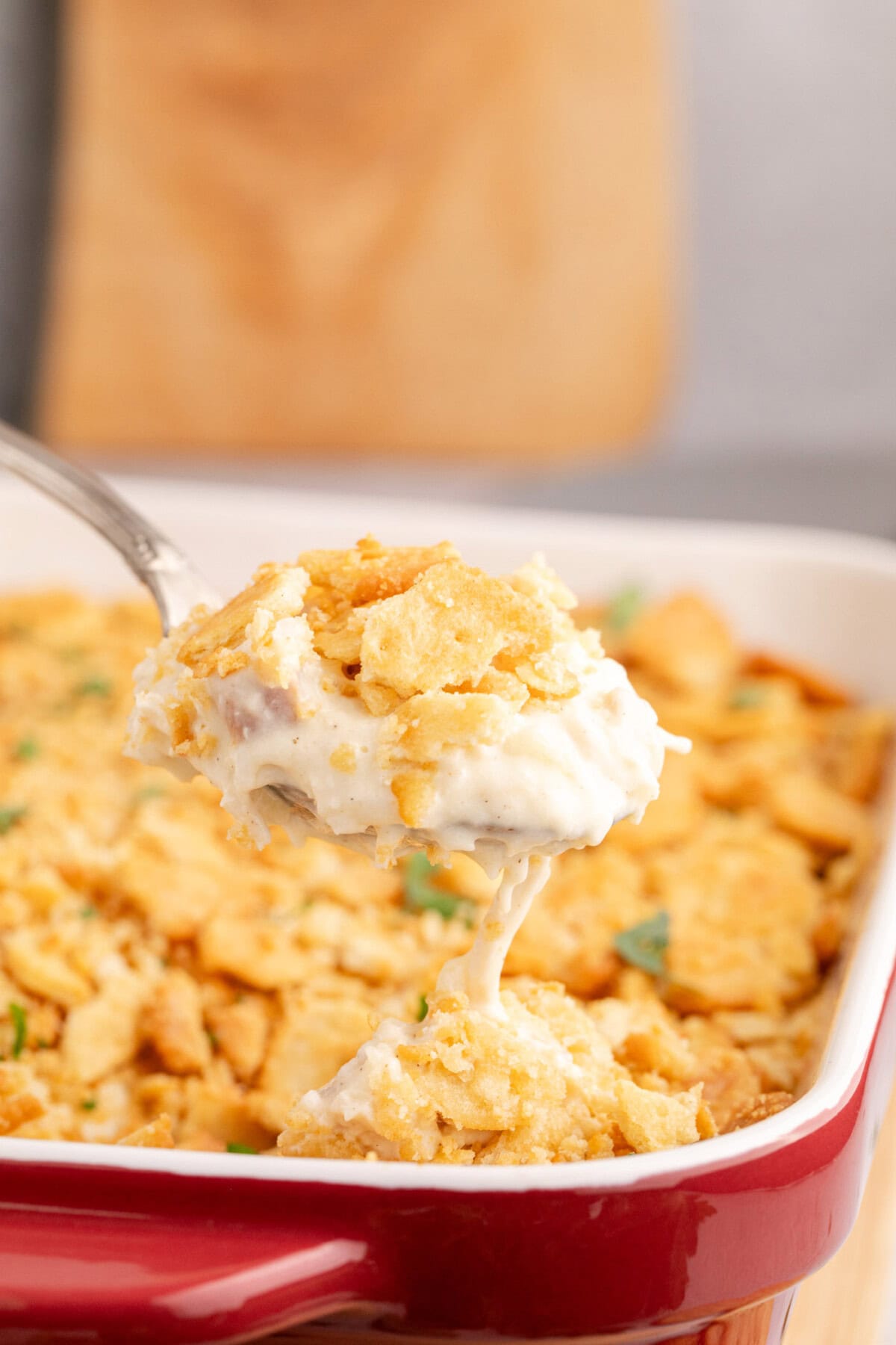 Spoonful of Ritz Cracker Chicken Casserole being lifted out of the dish