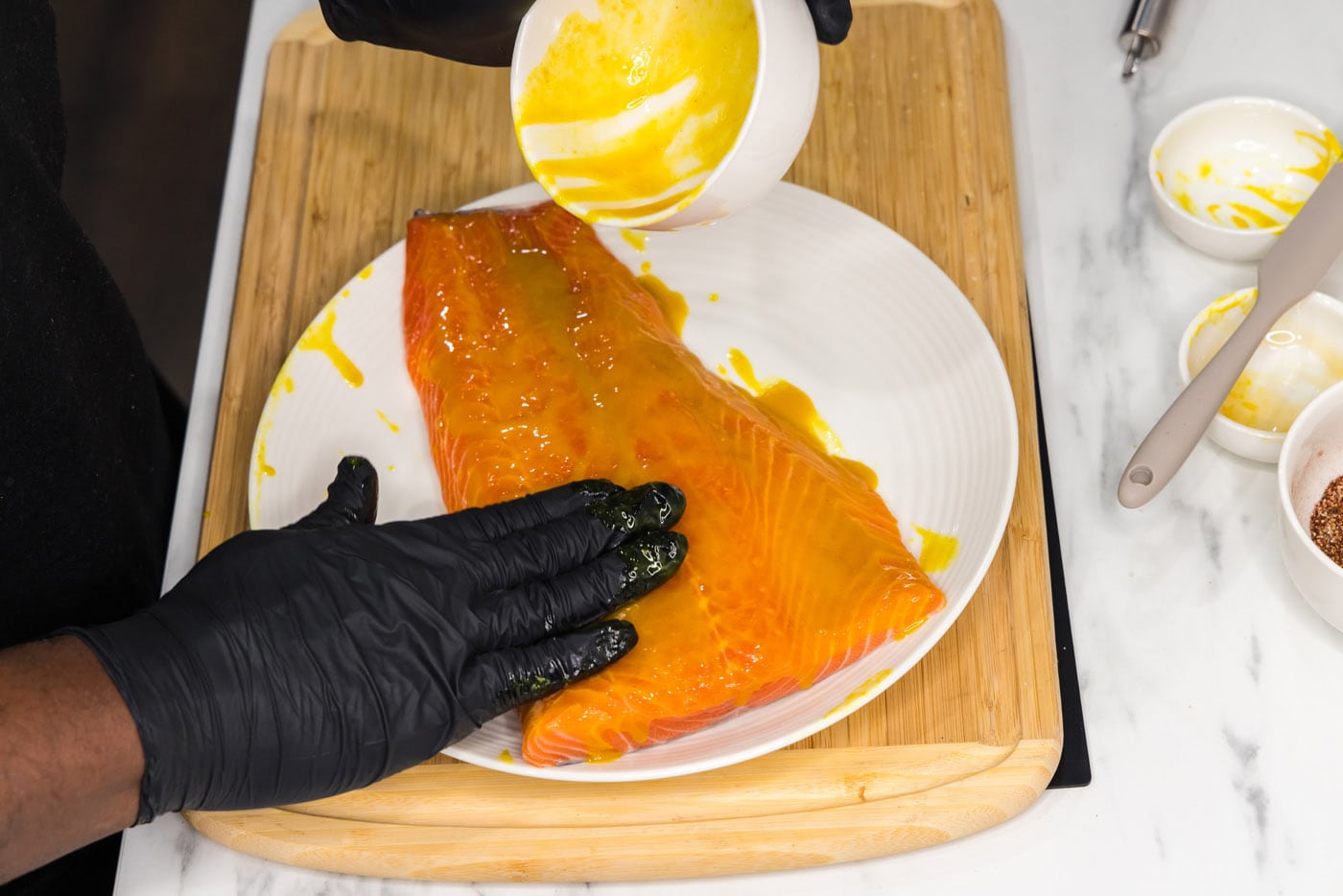 rubbing salmon filet with mustard and honey