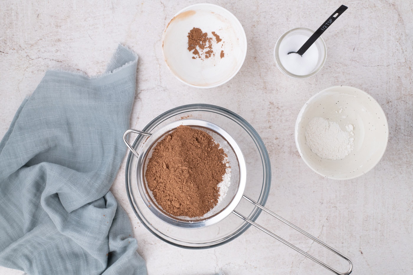 sifting flour and cocoa powder in a bowl