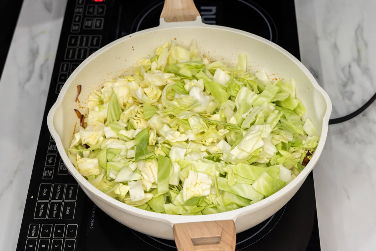 chopped cabbage added to skillet