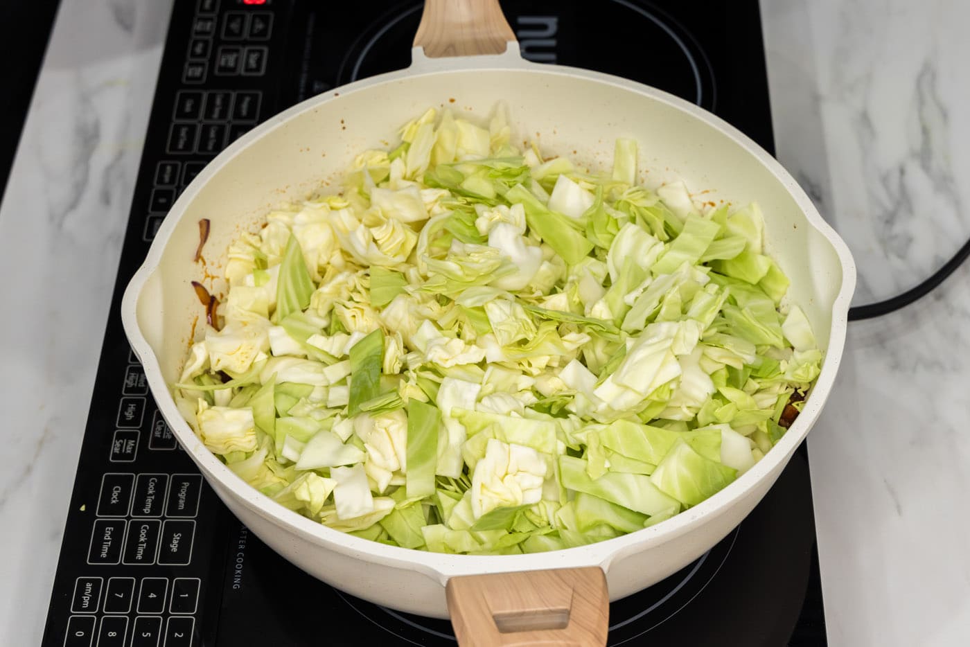 chopped cabbage added to skillet