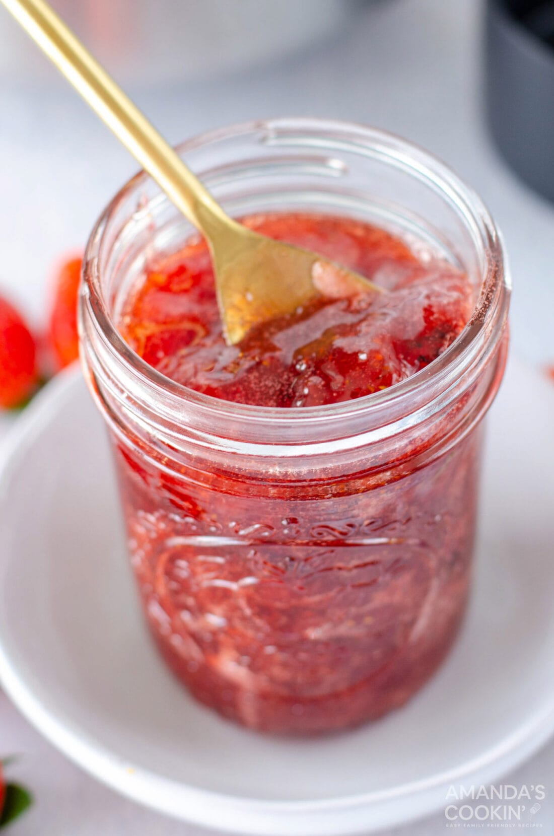 Jar of Strawberry Jam with a spoon in it