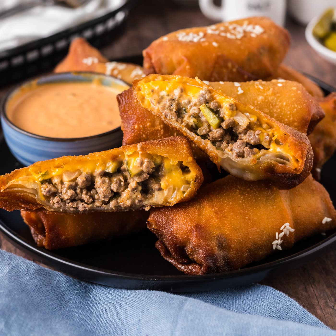 Big Mac Egg Roll cut in half resting on other Big Mac Egg Rolls