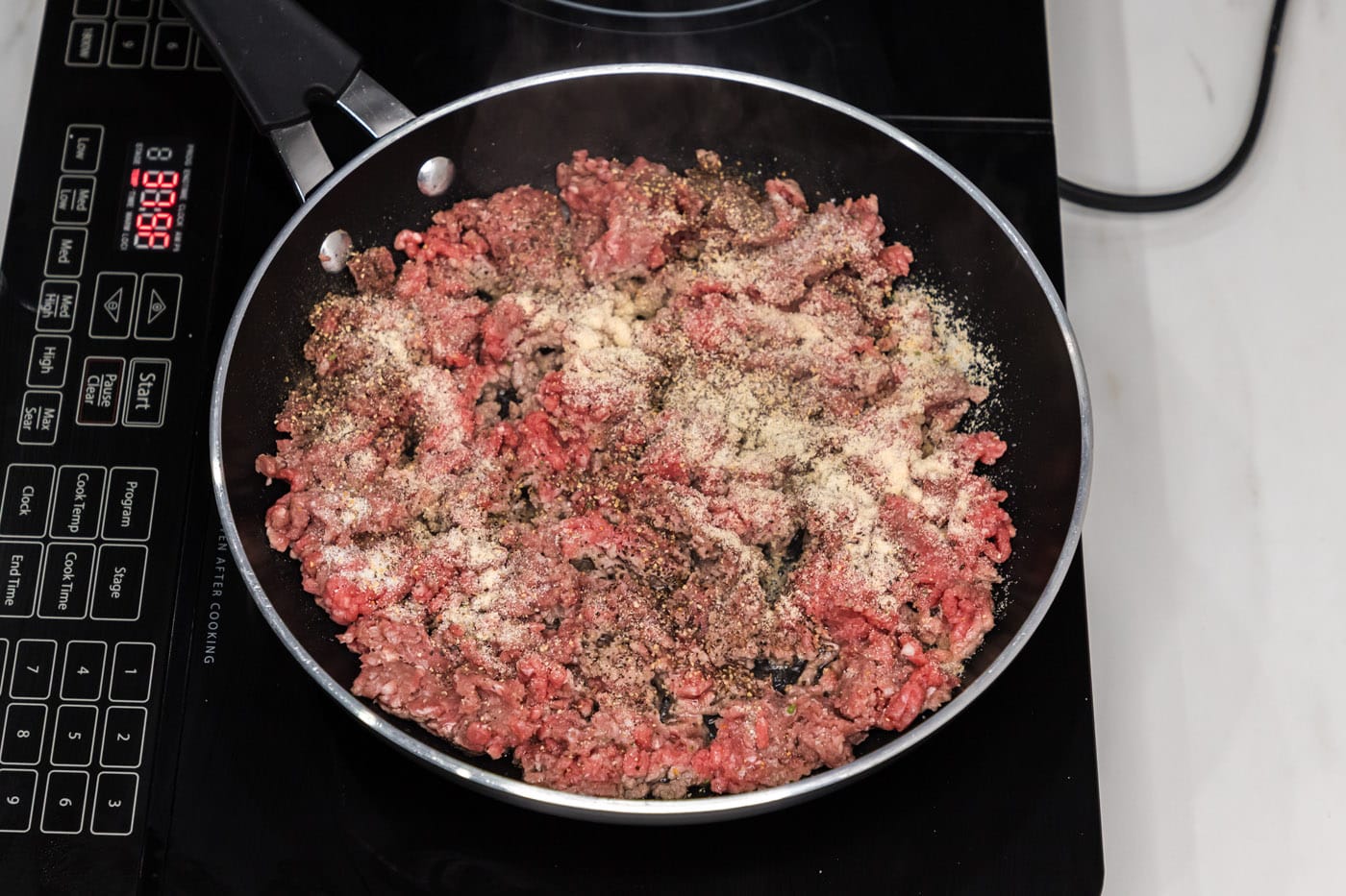 ground beef in a skillet with seasonings