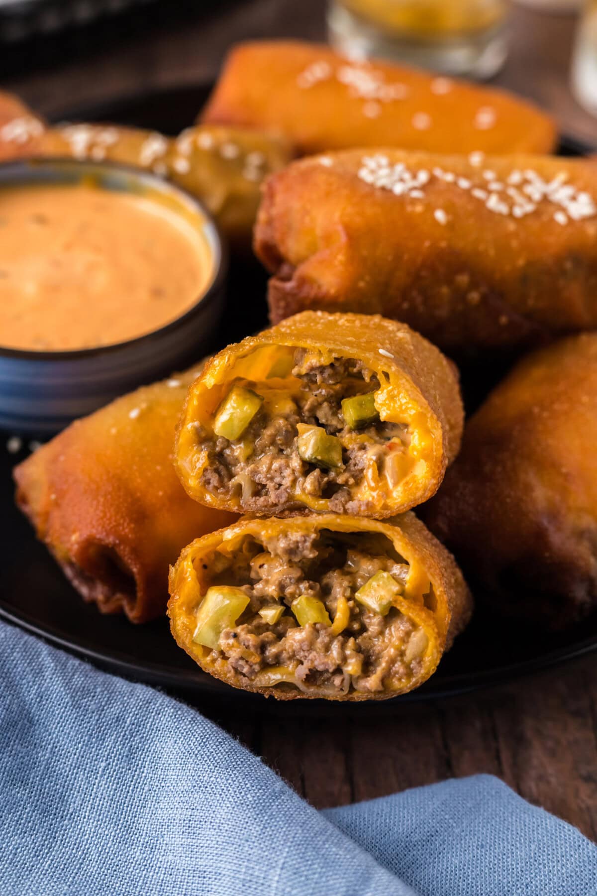 Close up photo of a Big Mac Egg Roll cut in half stacked on top of each other