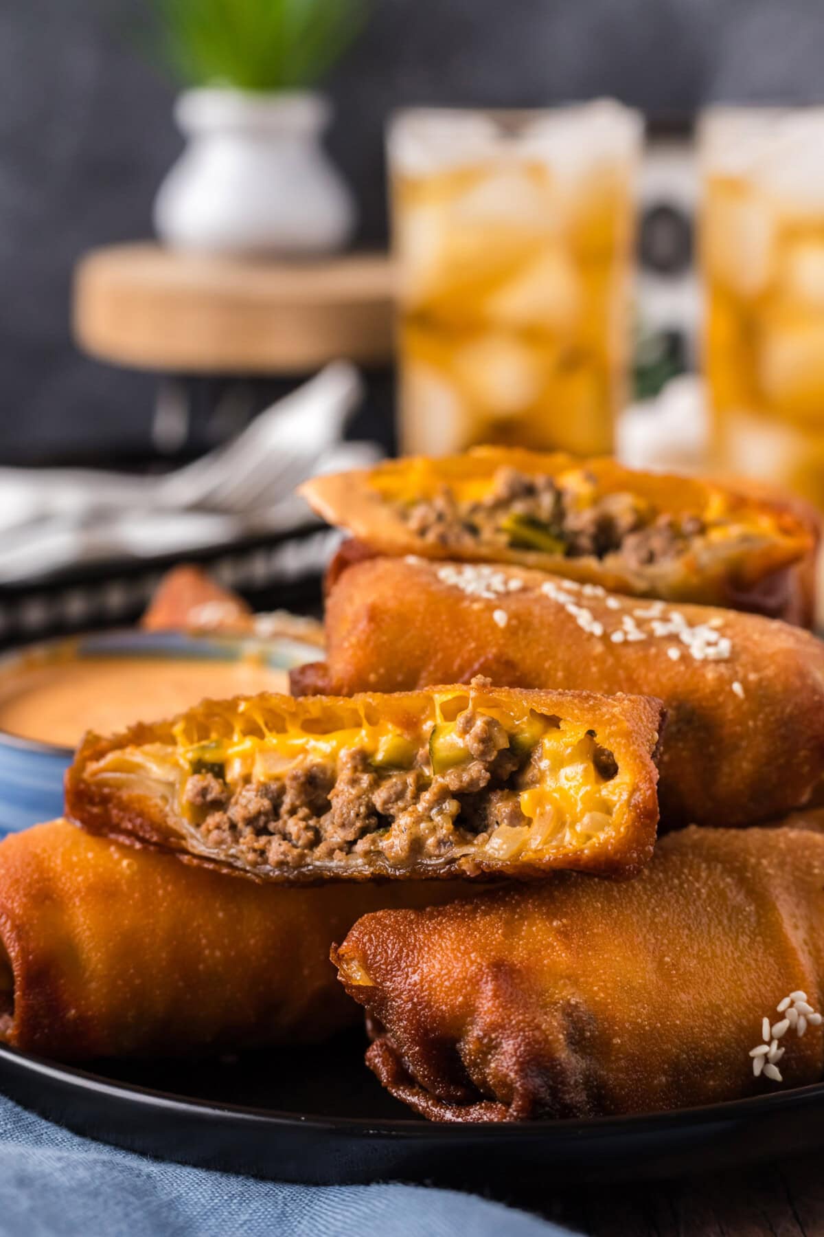 A Big Mac Egg Roll cut diagonally resting on top other Big Mac Egg Rolls