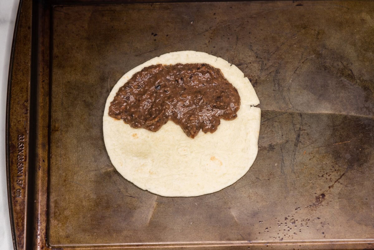 black bean mixture spread over tortilla