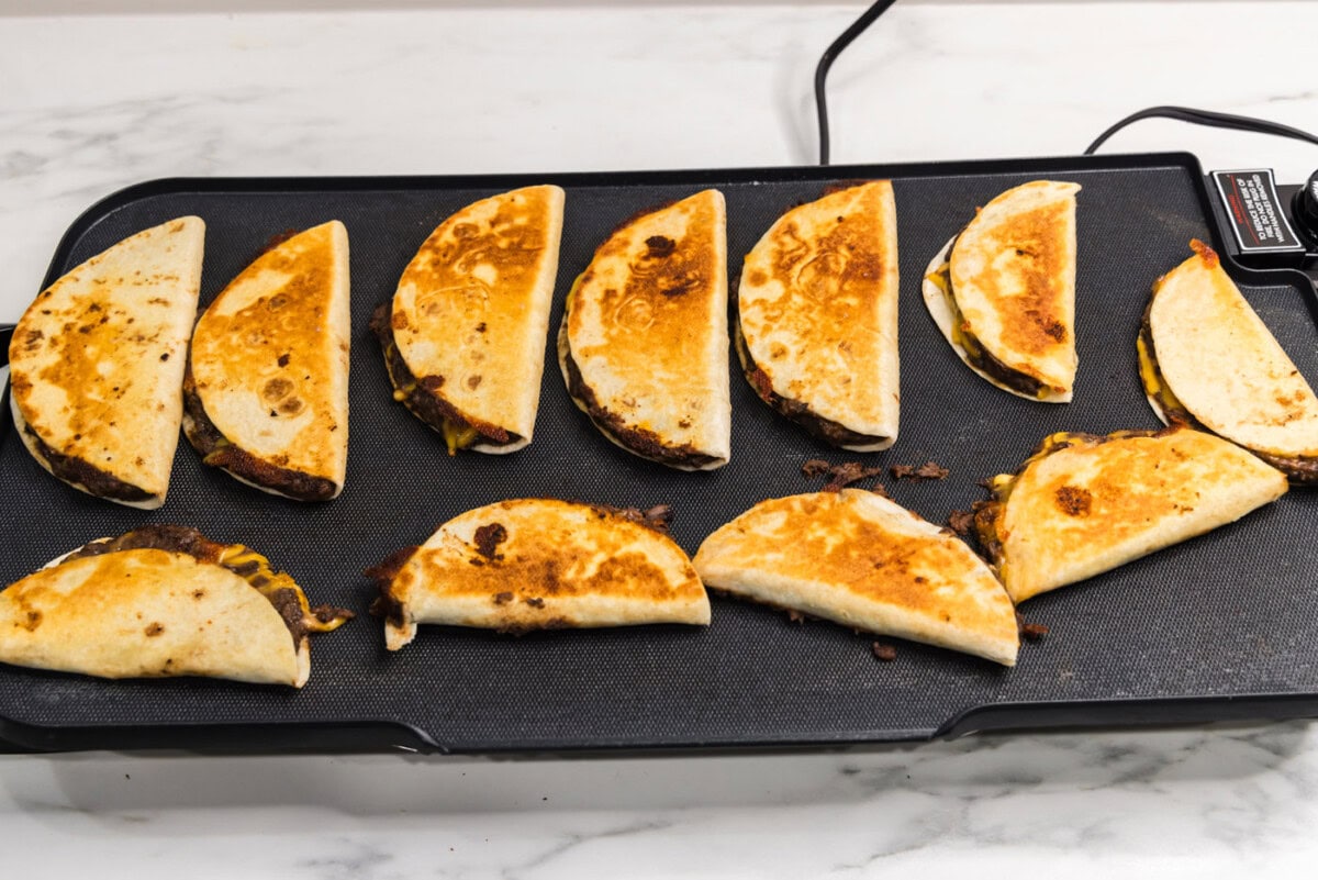 cooked black bean tacos on a griddle