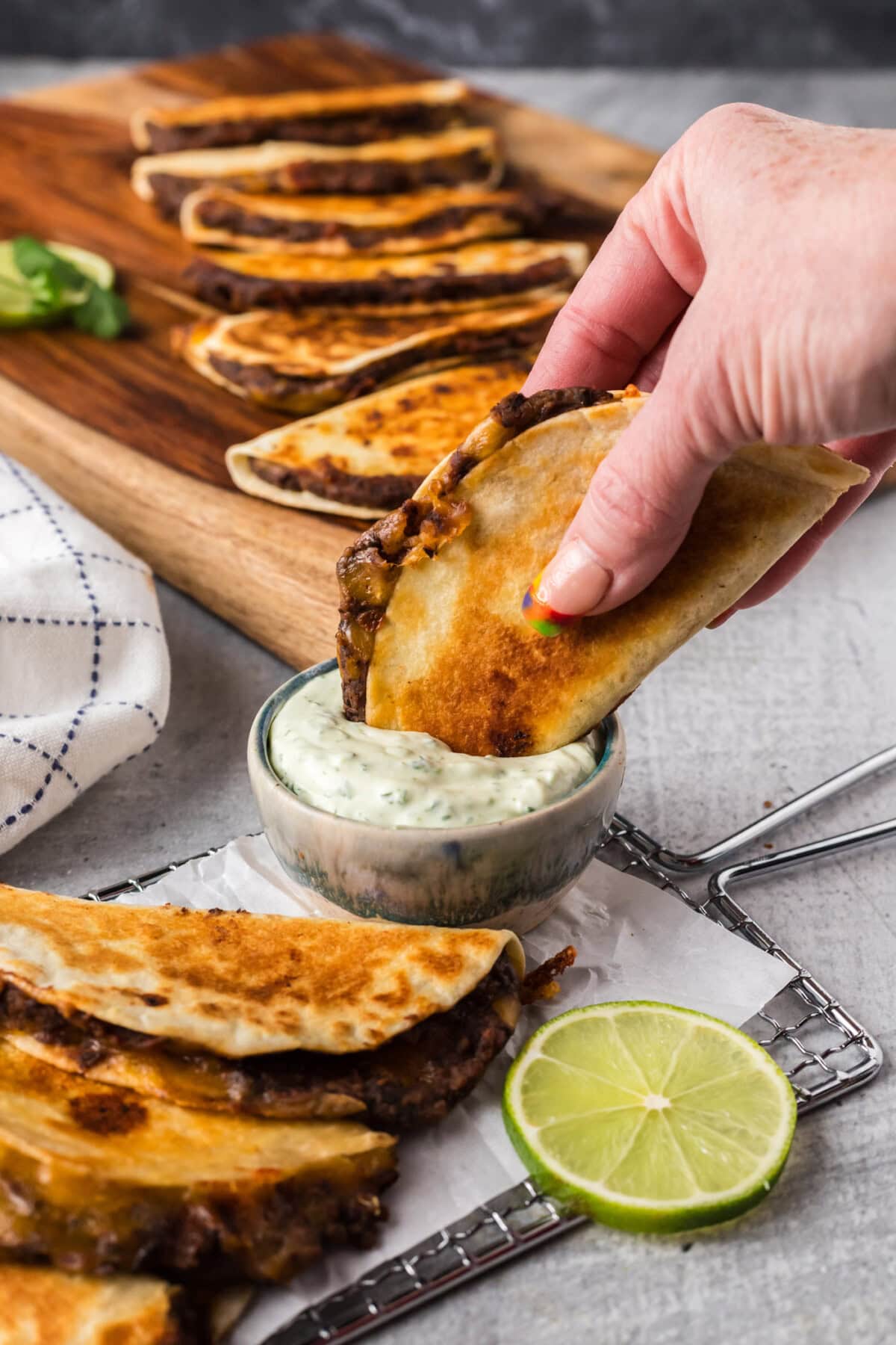 Black Bean Taco being dipped into a bowl of sauce