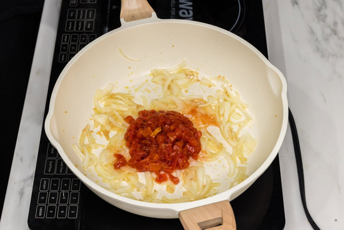 diced tomatoes added to skillet with onion and garlic