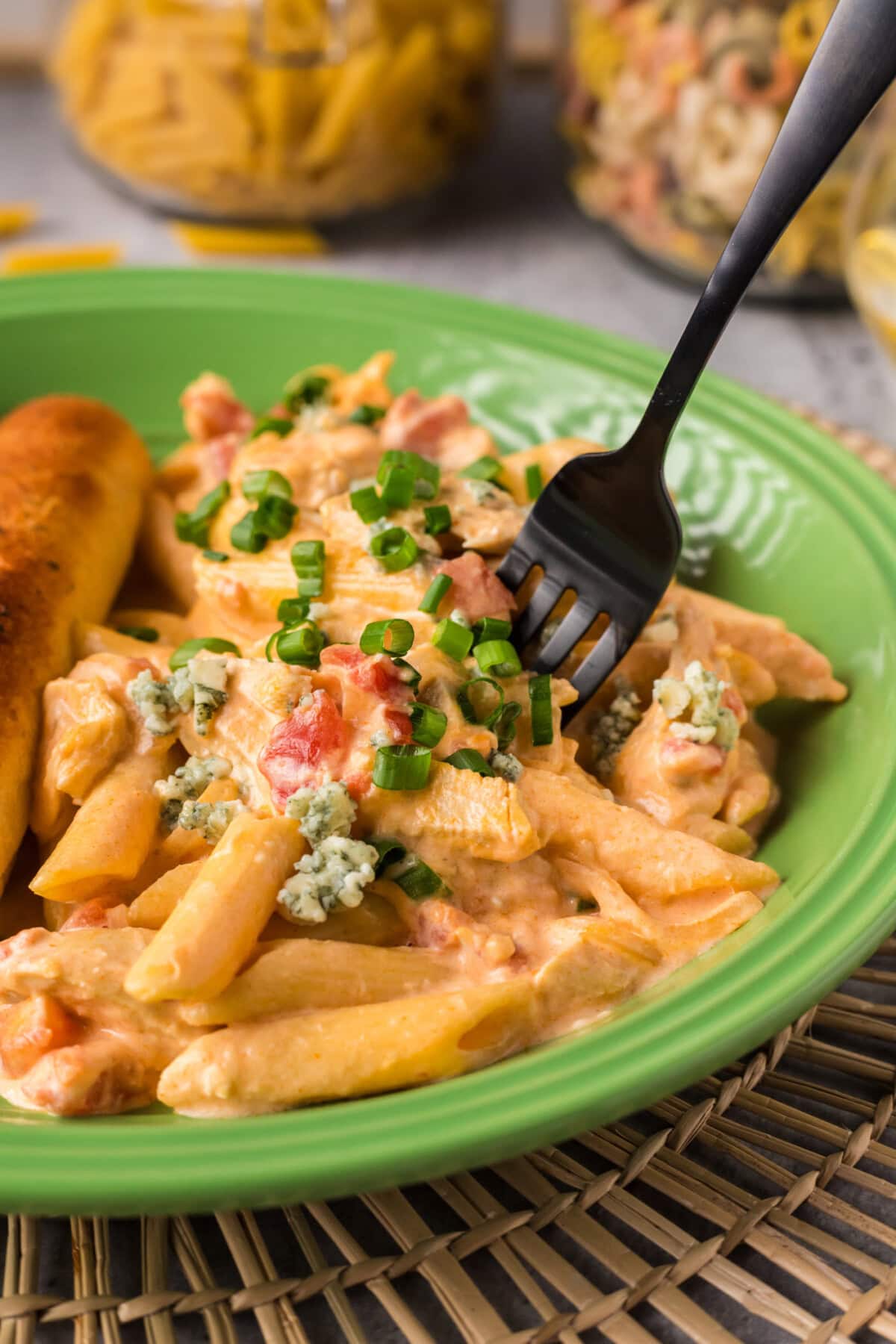 Fork stuck in a portion of Buffalo Chicken Pasta on a plate