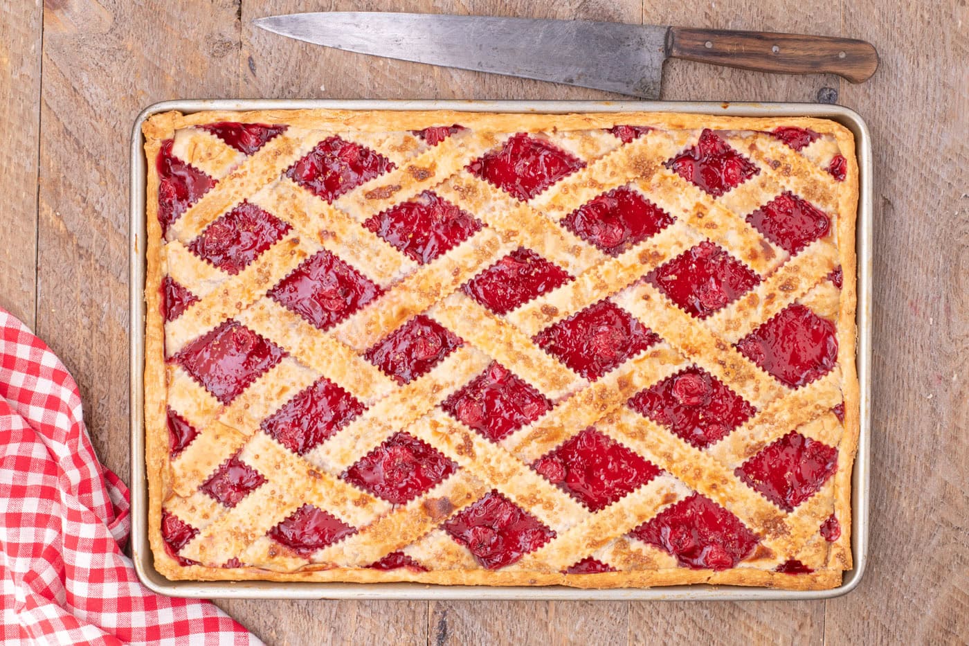 overhead of baked cherry slab pie in jelly roll pan