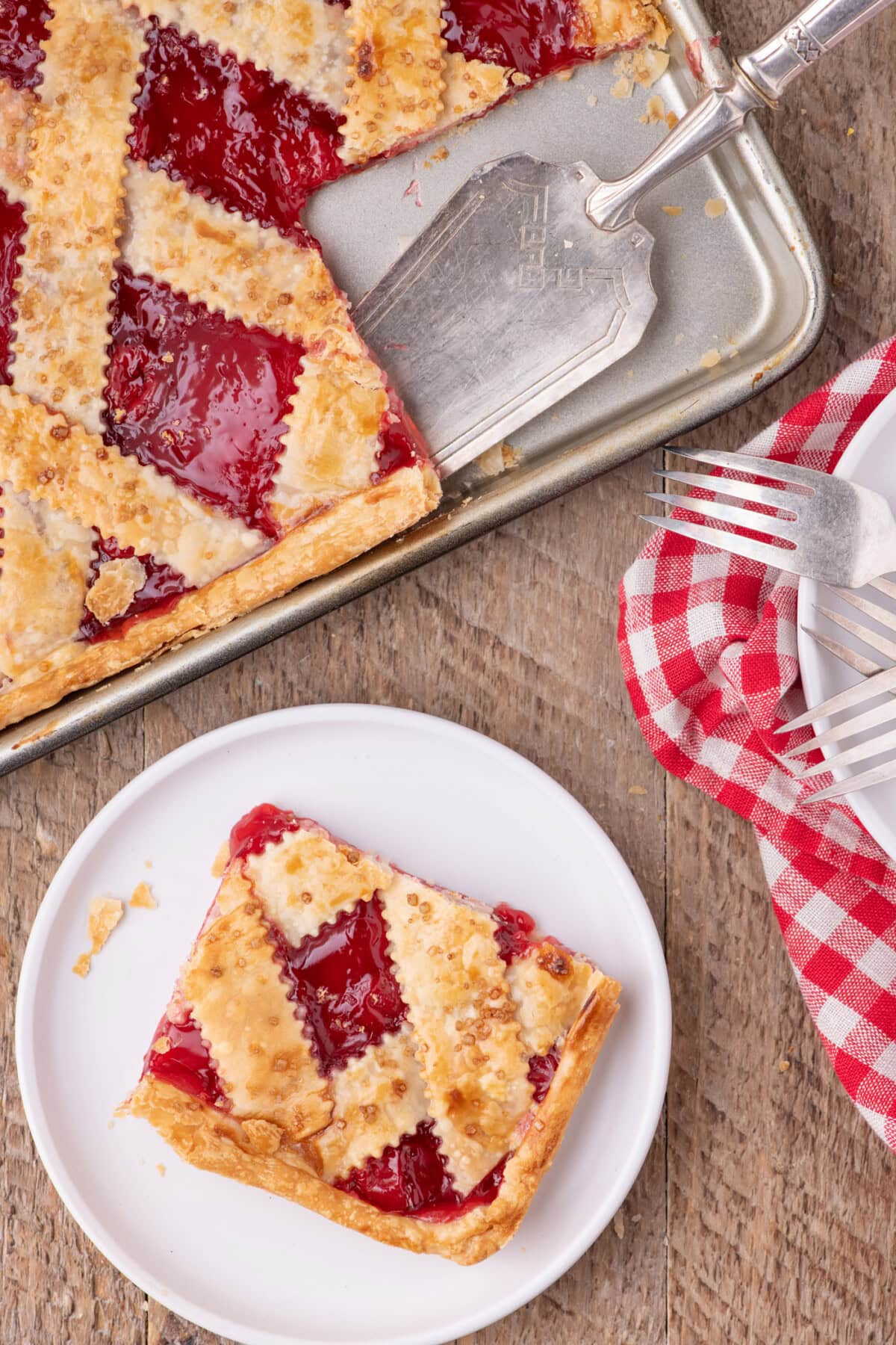 Slice of Cherry Slab Pie on a plate with the slab pie above it