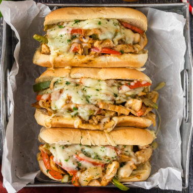 Close up photo of three Chicken Philly Cheesesteaks in a tray