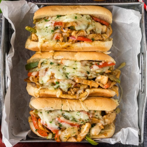 Close up photo of three Chicken Philly Cheesesteaks in a tray