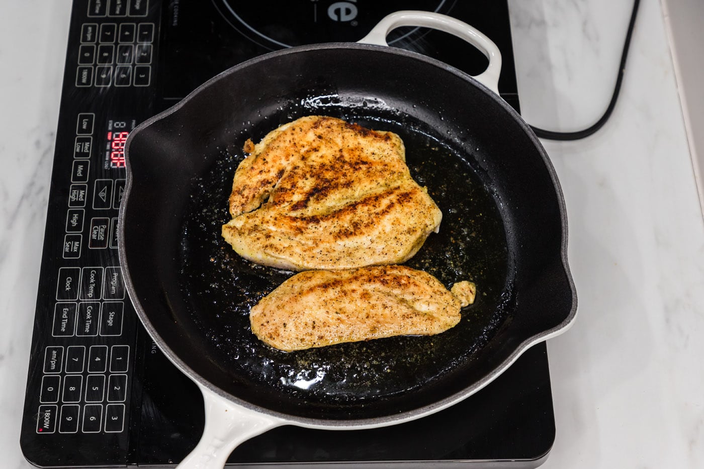 cooking chicken breast in a skillet