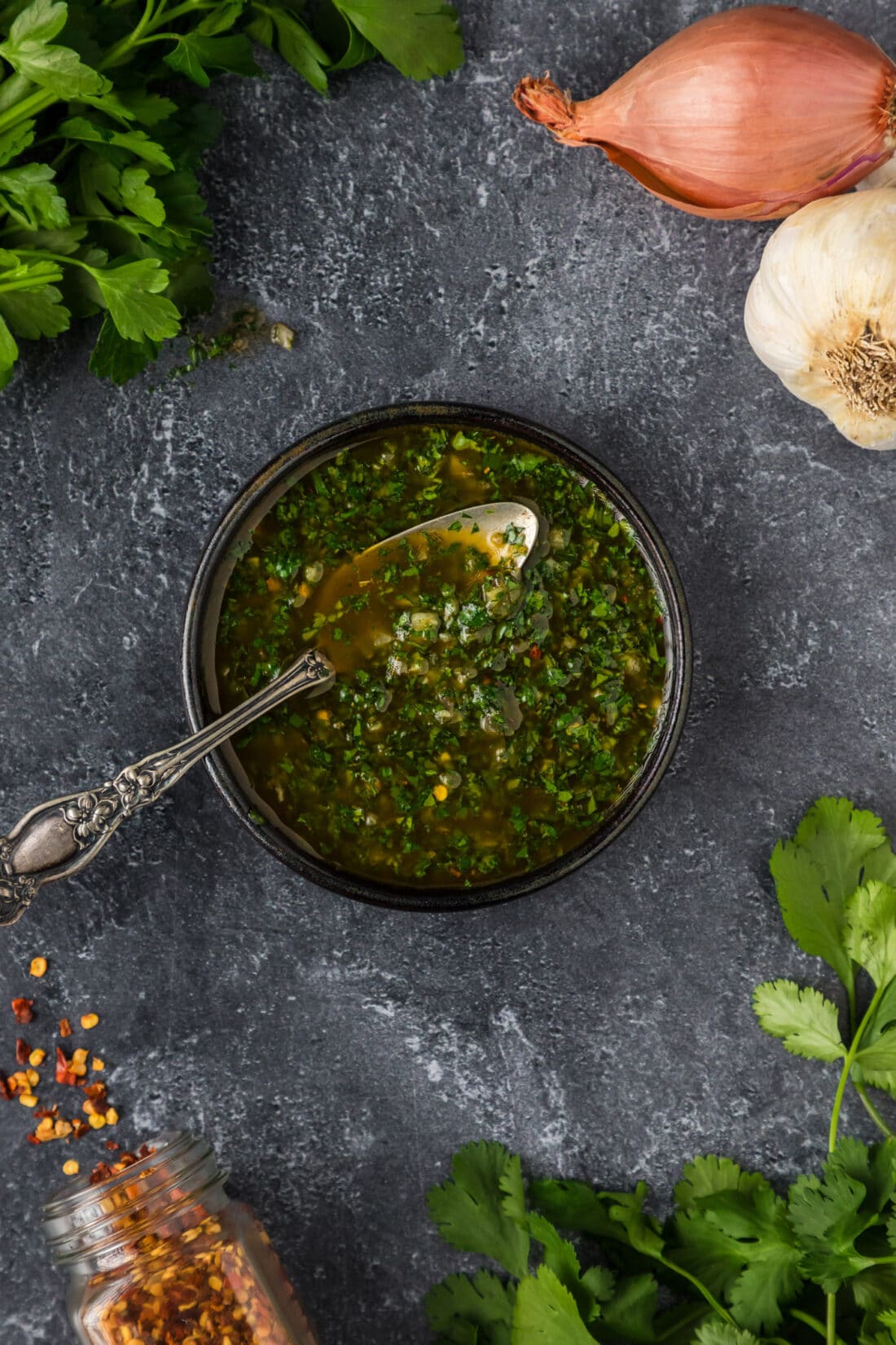 Bowl of Chimichurri with a spoon in it
