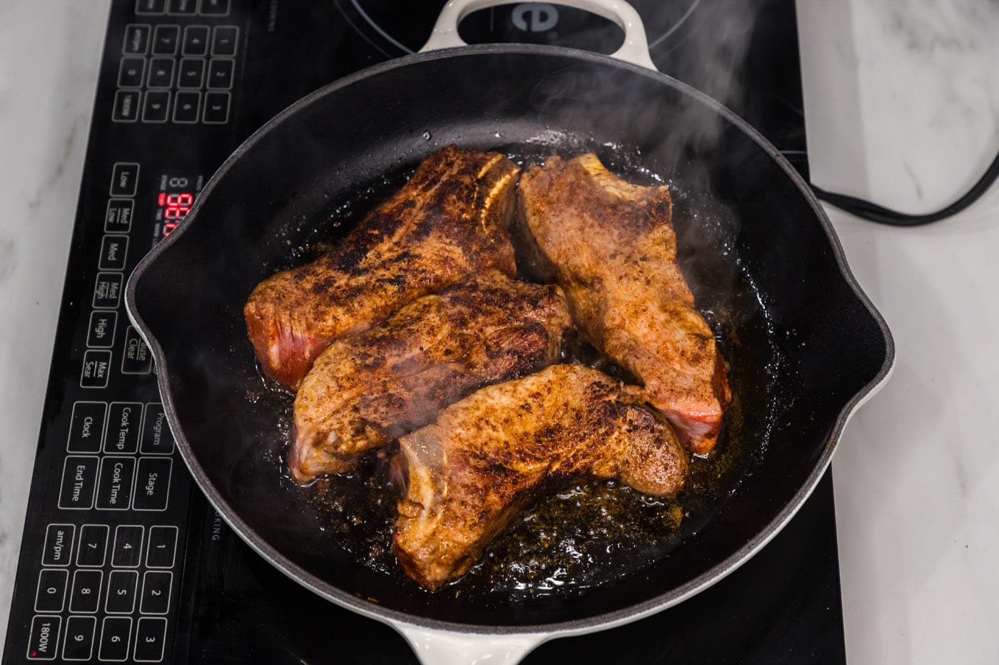 seared pork ribs in a skillet