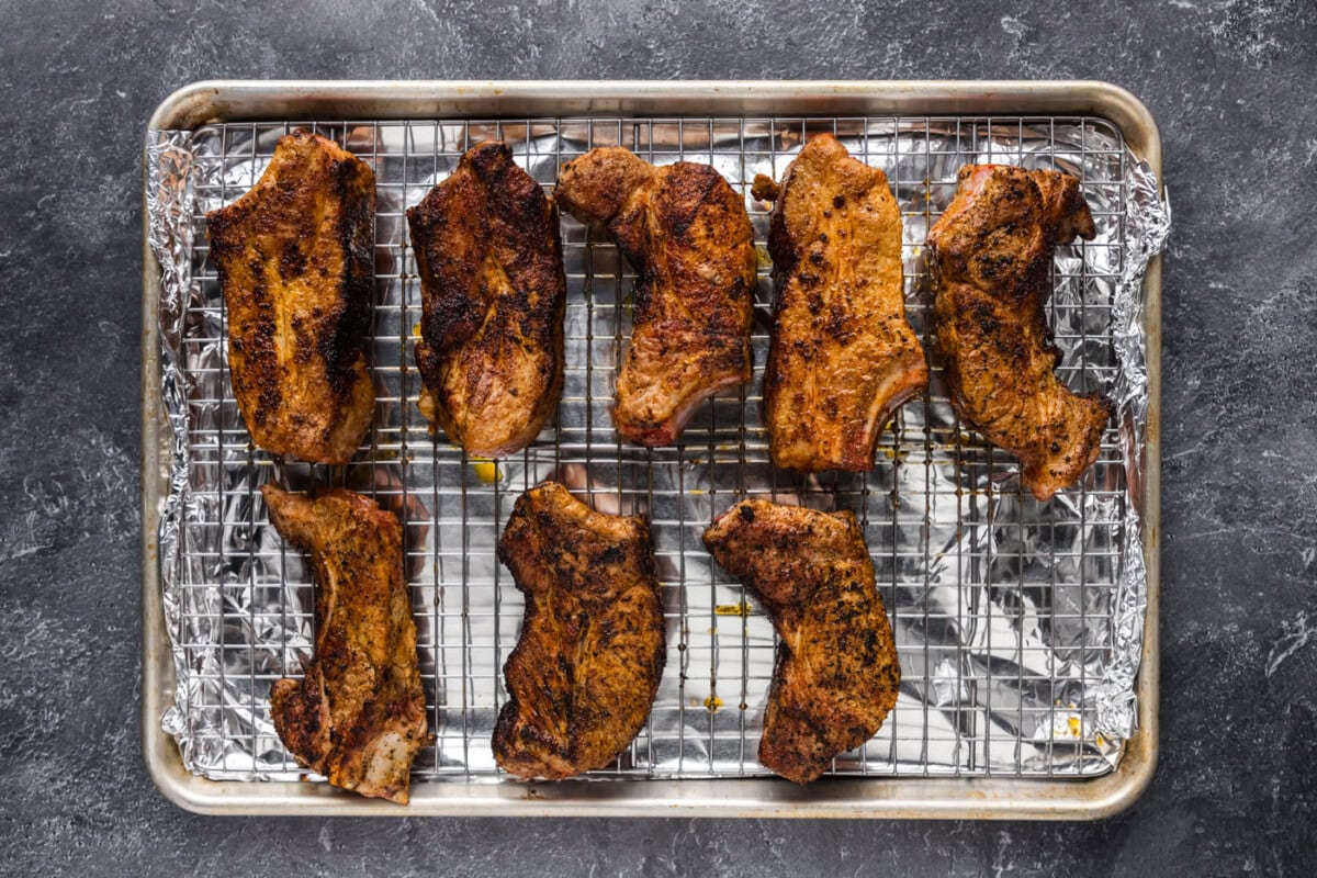 pork ribs on a wire rack over a baking sheet