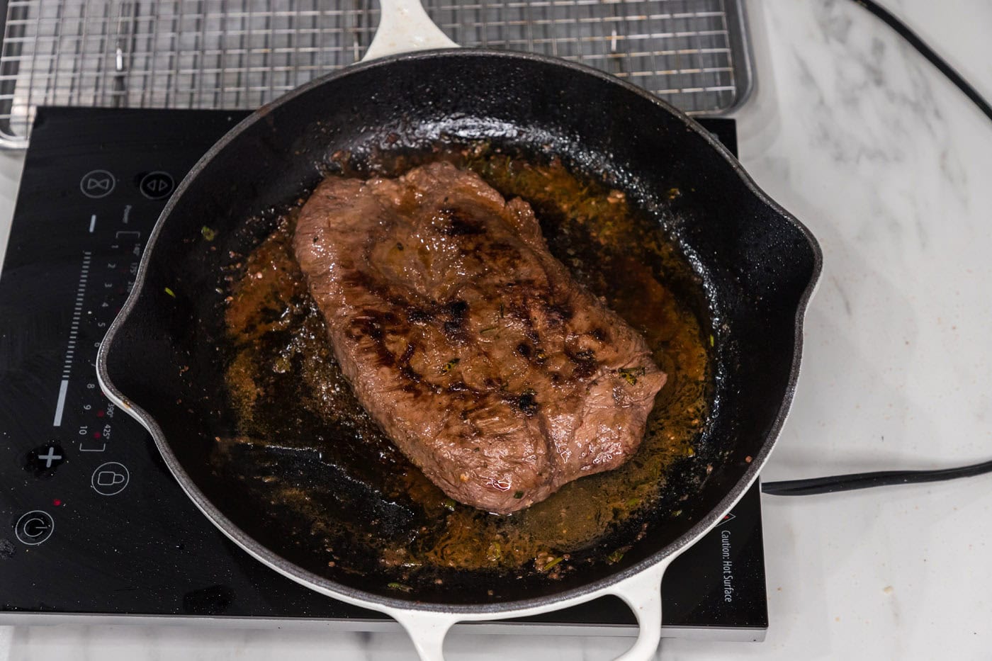 seared cooked flat iron steak in a skillet