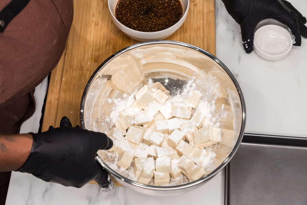 tossing tofu cubes with cornstarch