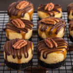 Mini Turtle Cheesecakes resting on a cooling rack