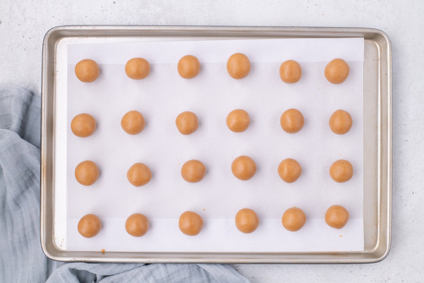 nutter butter cookie balls on a baking sheet