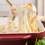 Spoonful of Philly Chicken Cheesesteak Casserole being lifted up from the casserole dish
