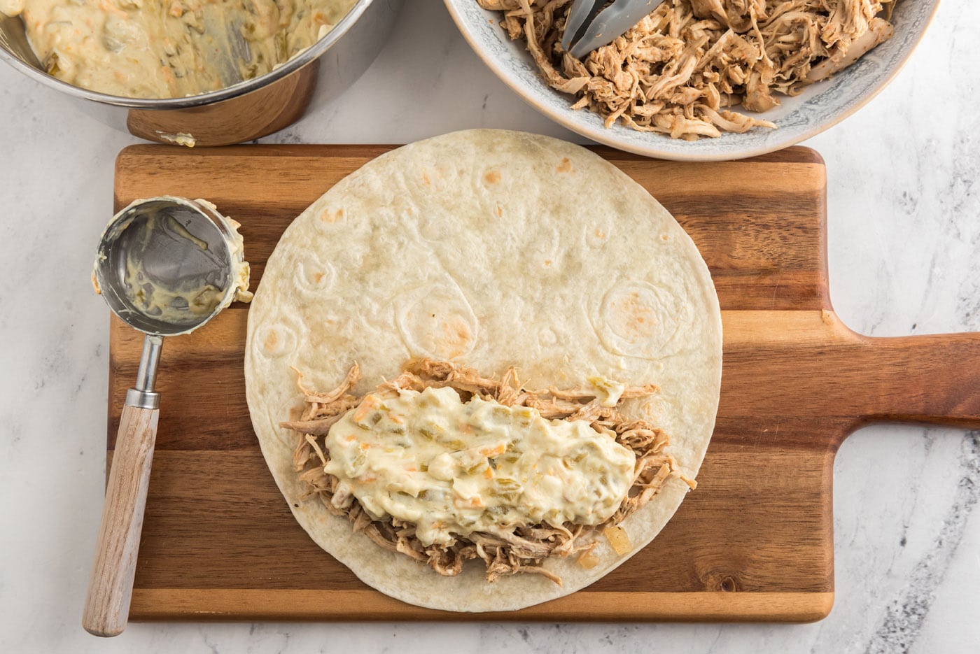 creamy chile sauce on top of shredded chicken tortilla