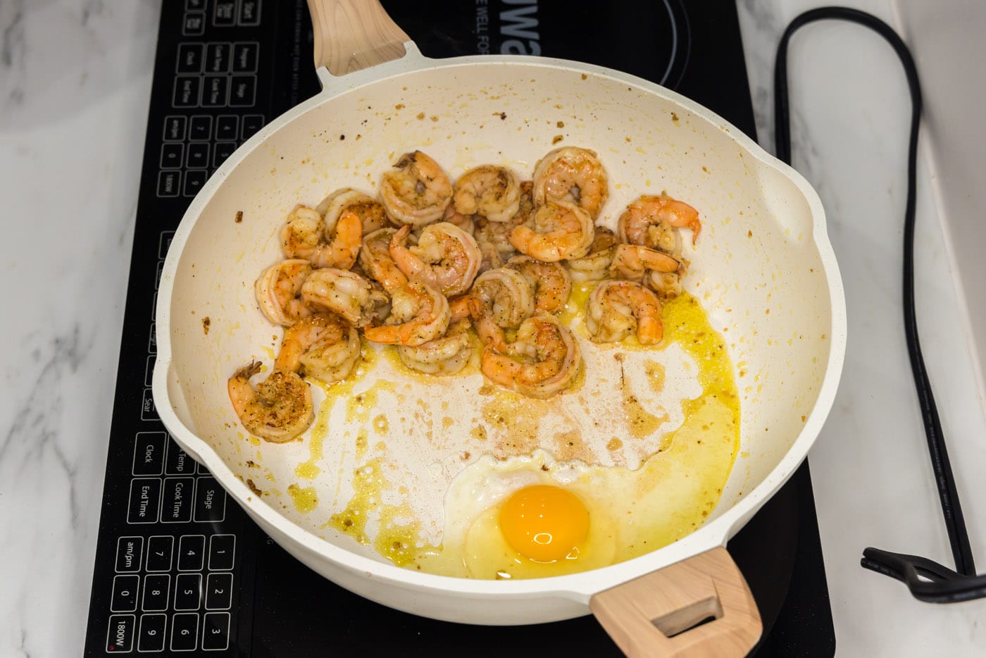 sauteed shrimp with egg in a skillet