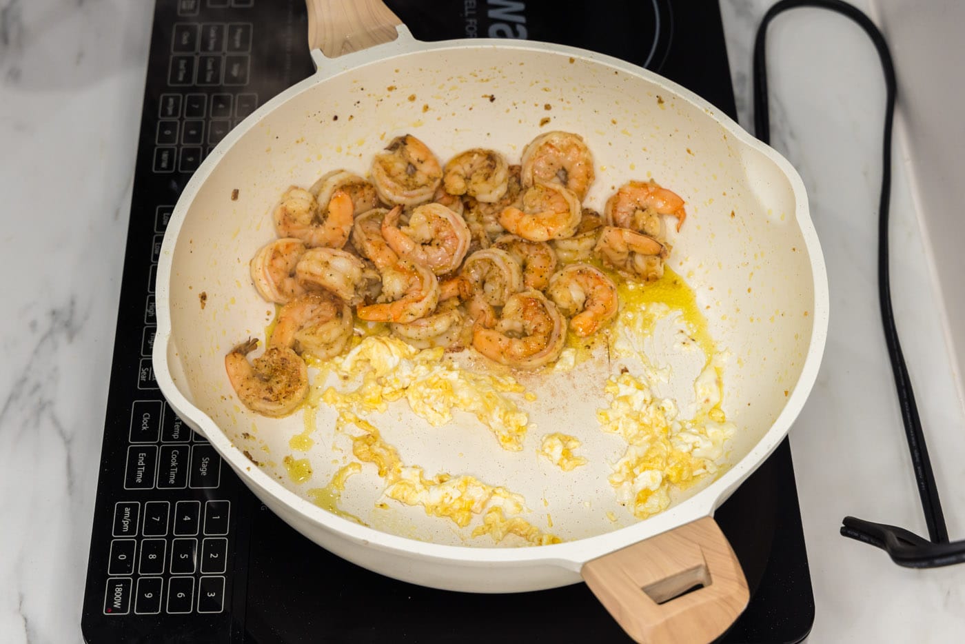 scrambled egg in a skillet with shrimp