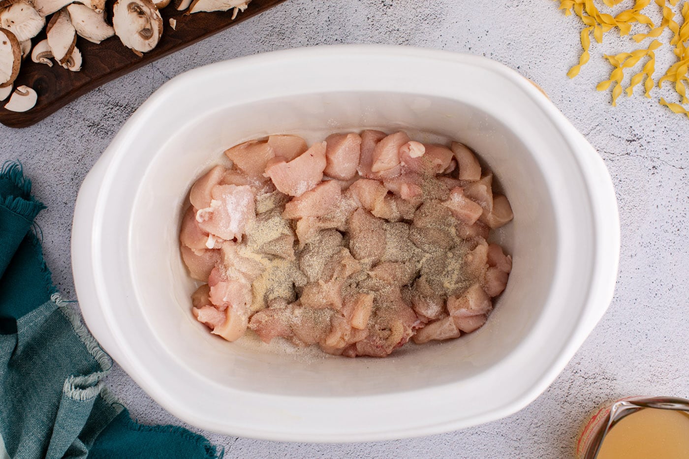 seasoned chicken cubes in a crock pot