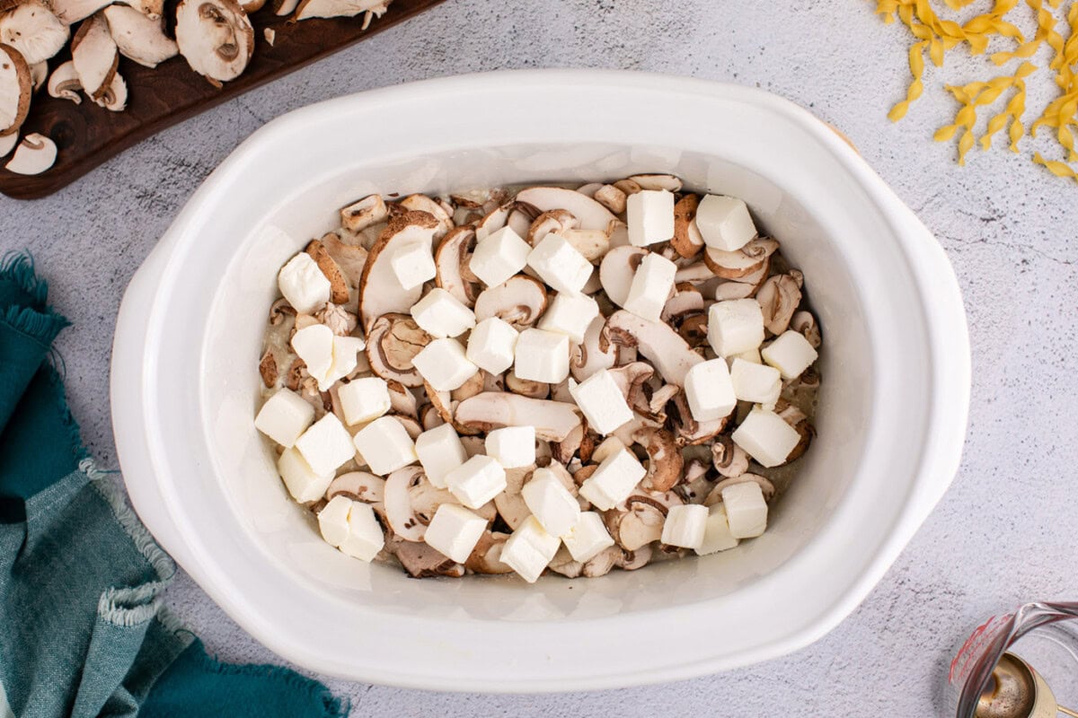 cubed cream cheese on top of chicken and mushroom stroganoff