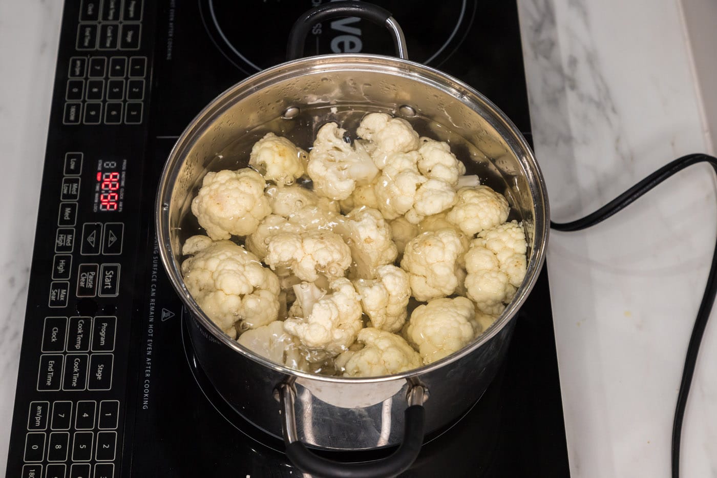 cauliflower florets boiling in water
