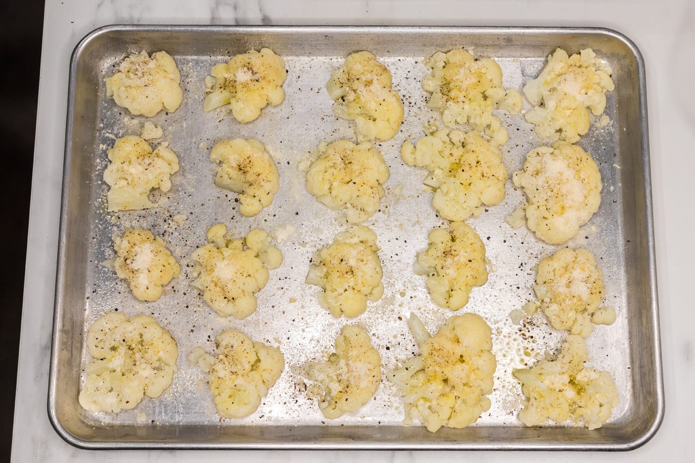 smashed cauliflower with parmesan cheese and seasonings