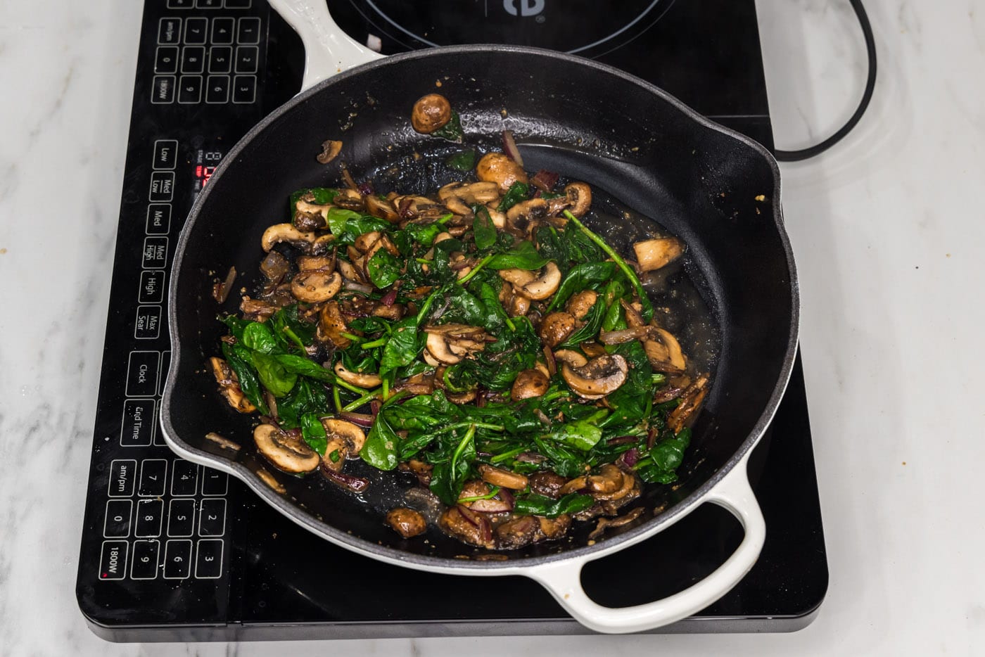 sauteed spinach and mushrooms in a skillet