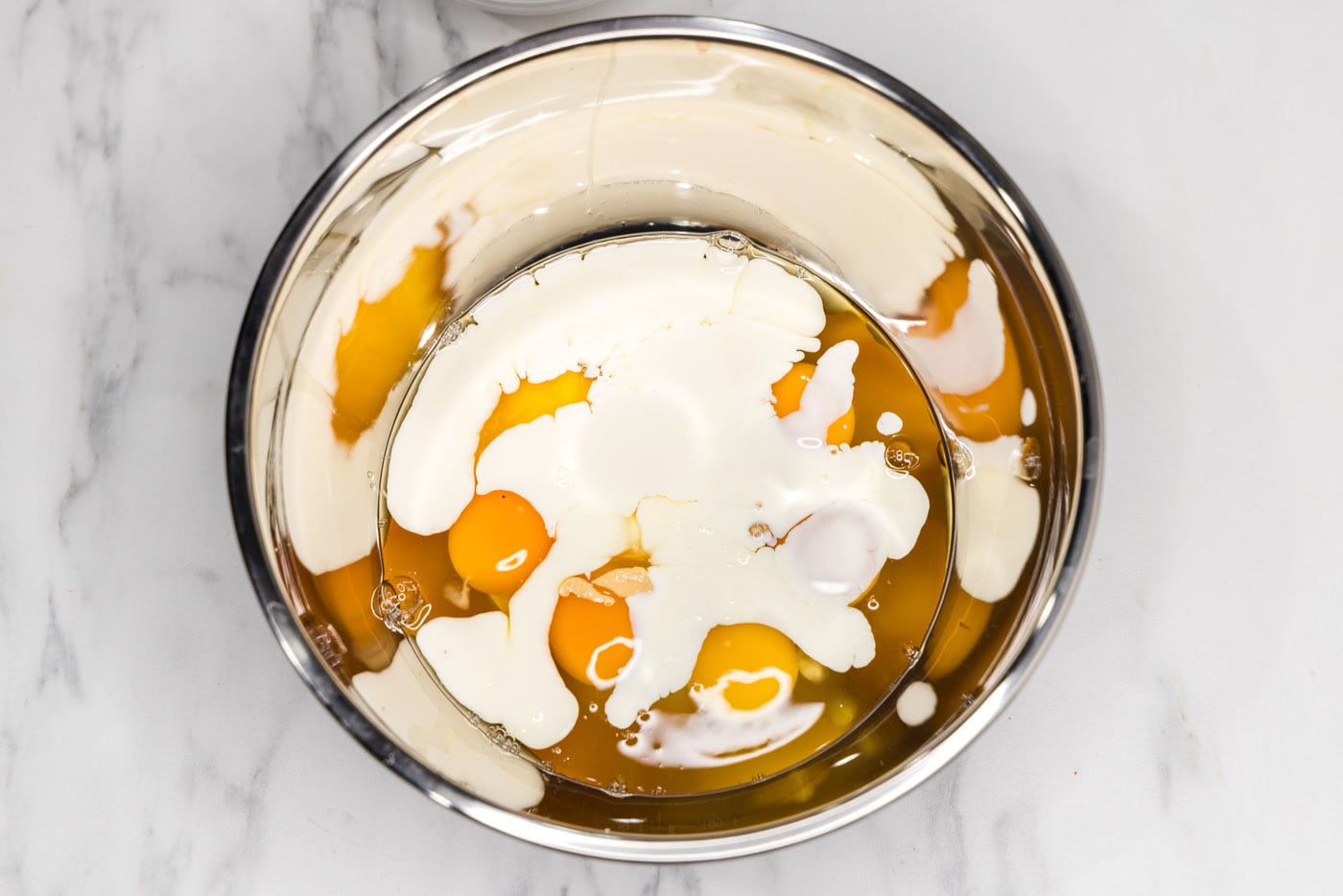 heavy cream, Dijon mustard, and eggs in a bowl