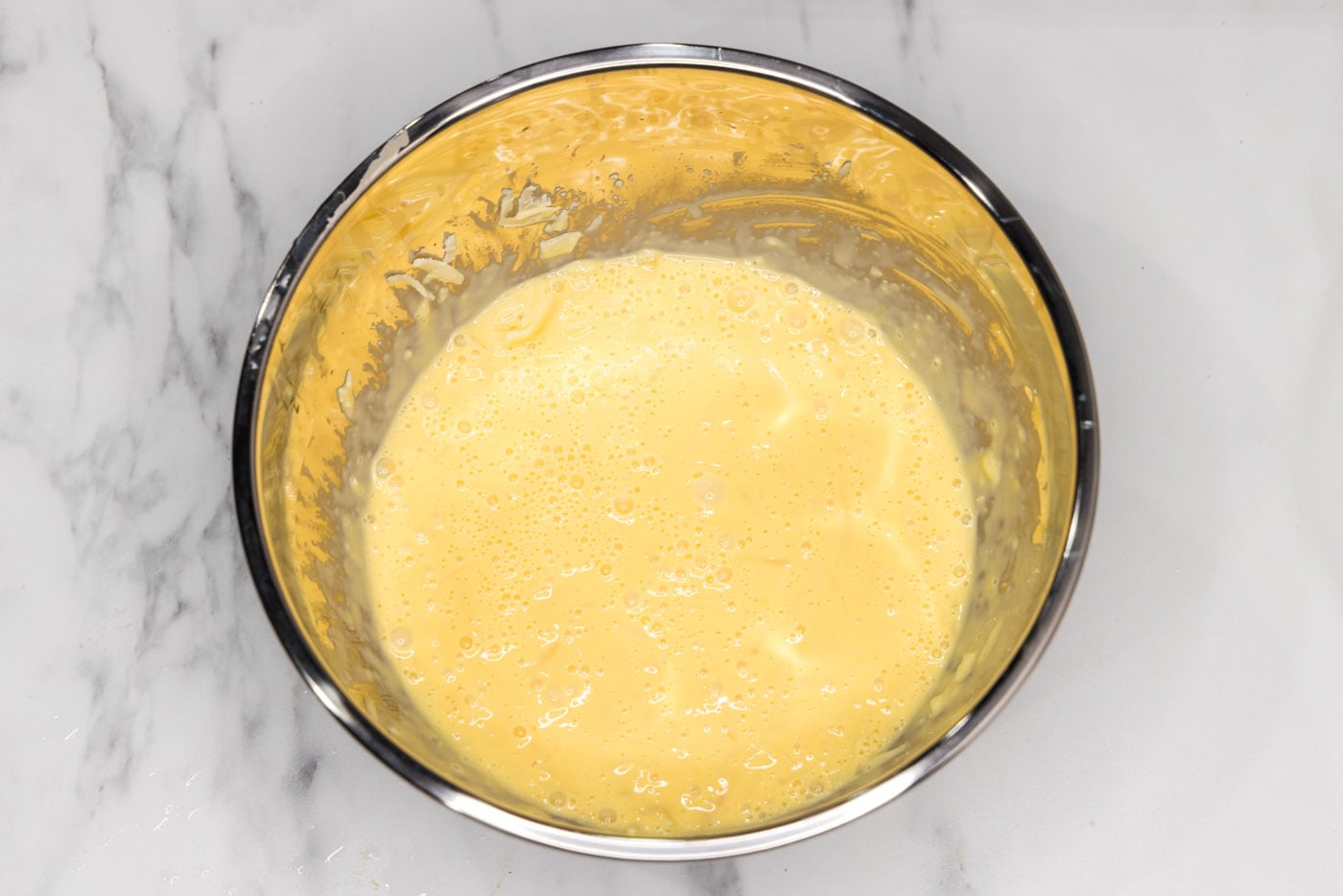whipped egg, mustard, and heavy cream mixture in a bowl