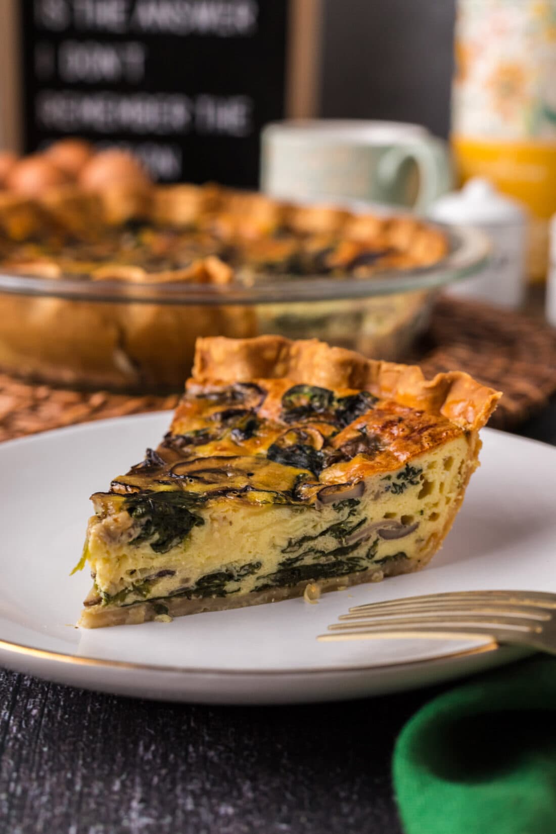 Slice of Spinach Mushroom Quiche on a plate