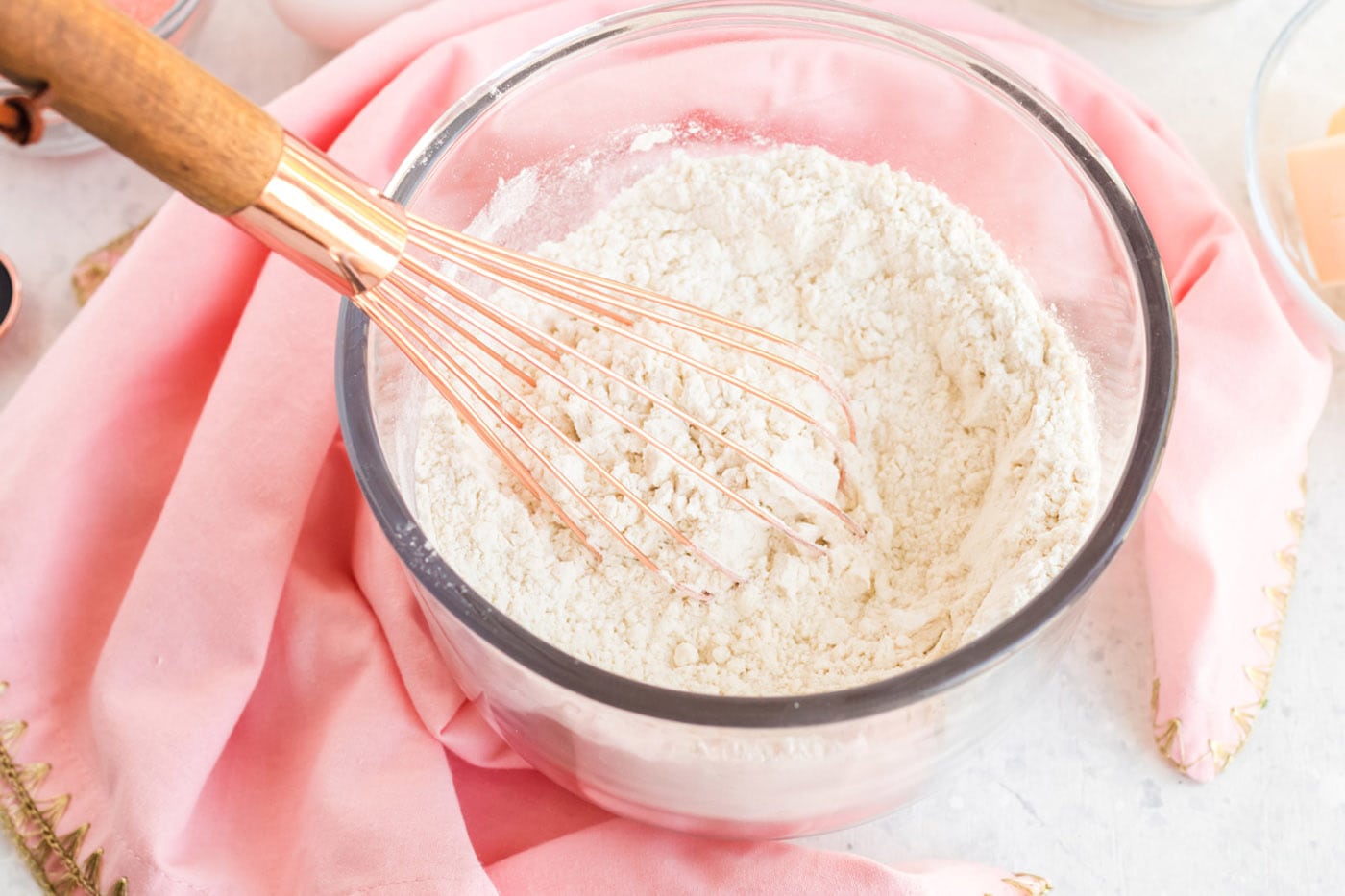 Cake flour, baking powder and salt in a bowl with a whisk